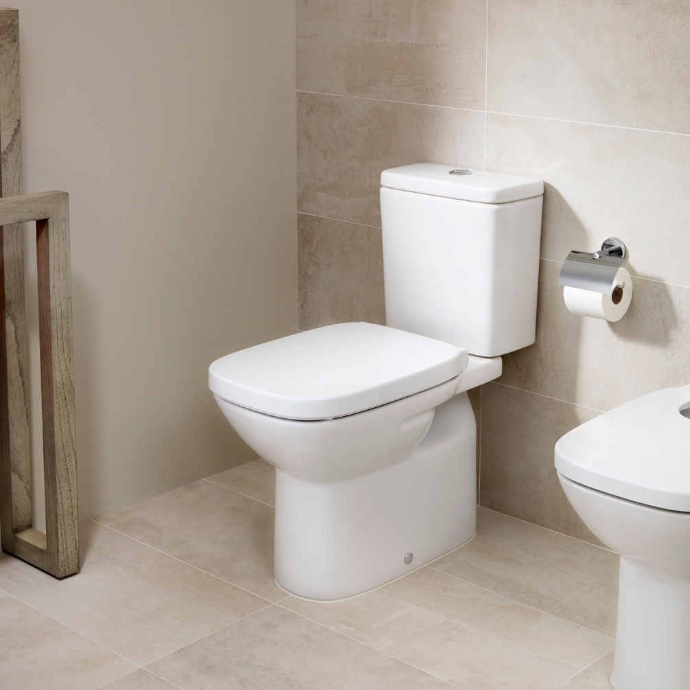 Lifestyle image of the Roca Debba Square Close Coupled Open Back Toilet installed in a bathroom, next to a bidet